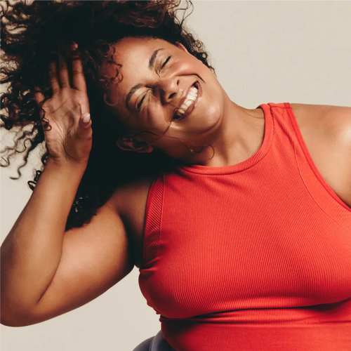 Plus size woman smiling while dancing