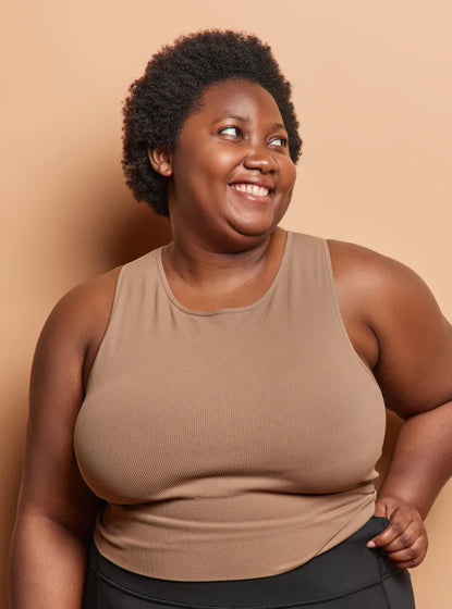 Plus size woman in fitness clothing smiling