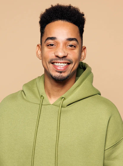 Young african-american man wearing a hoodie smiling at camera