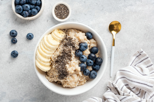 overhead photo of a bowl of oatmeal with sliced bananas, chia seeds, and blueberries as part of a GLP-1 diet