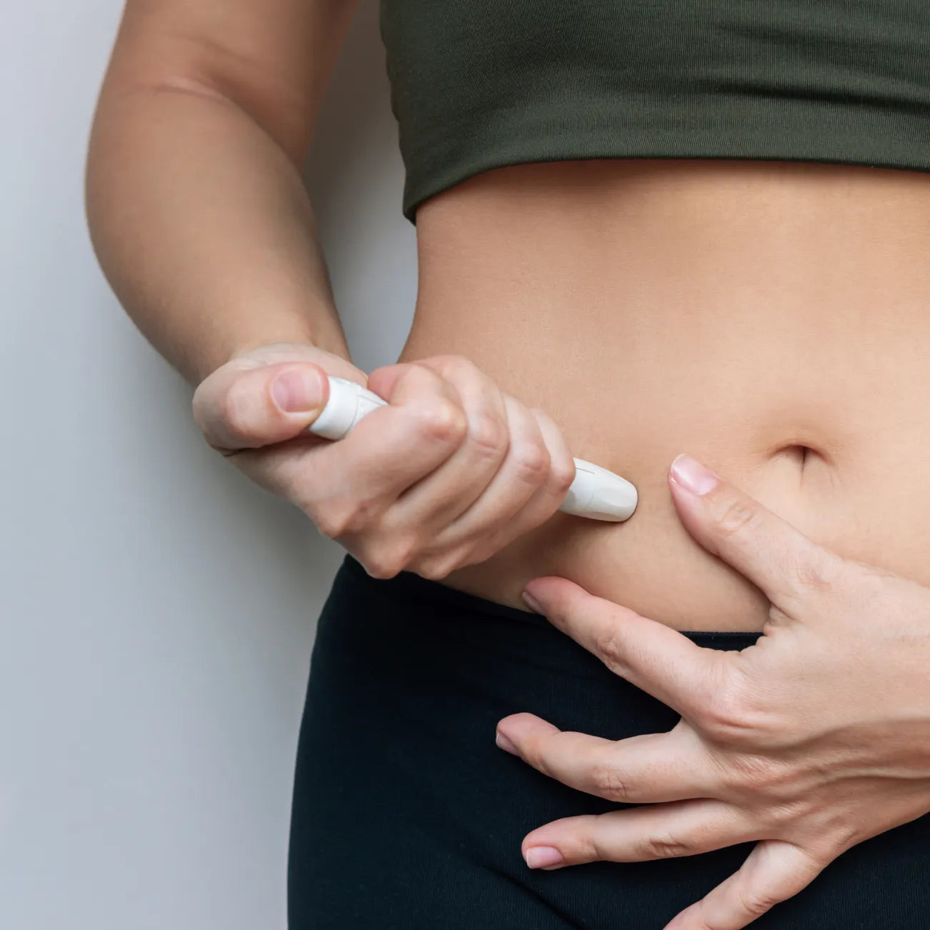 Woman self-injecting a GLP-1 shot